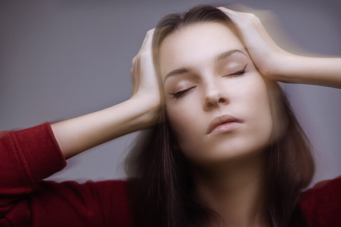 Blurry photo of women feeling dizzy |  The 16 Most Common KETO Side Effects and Remedies
