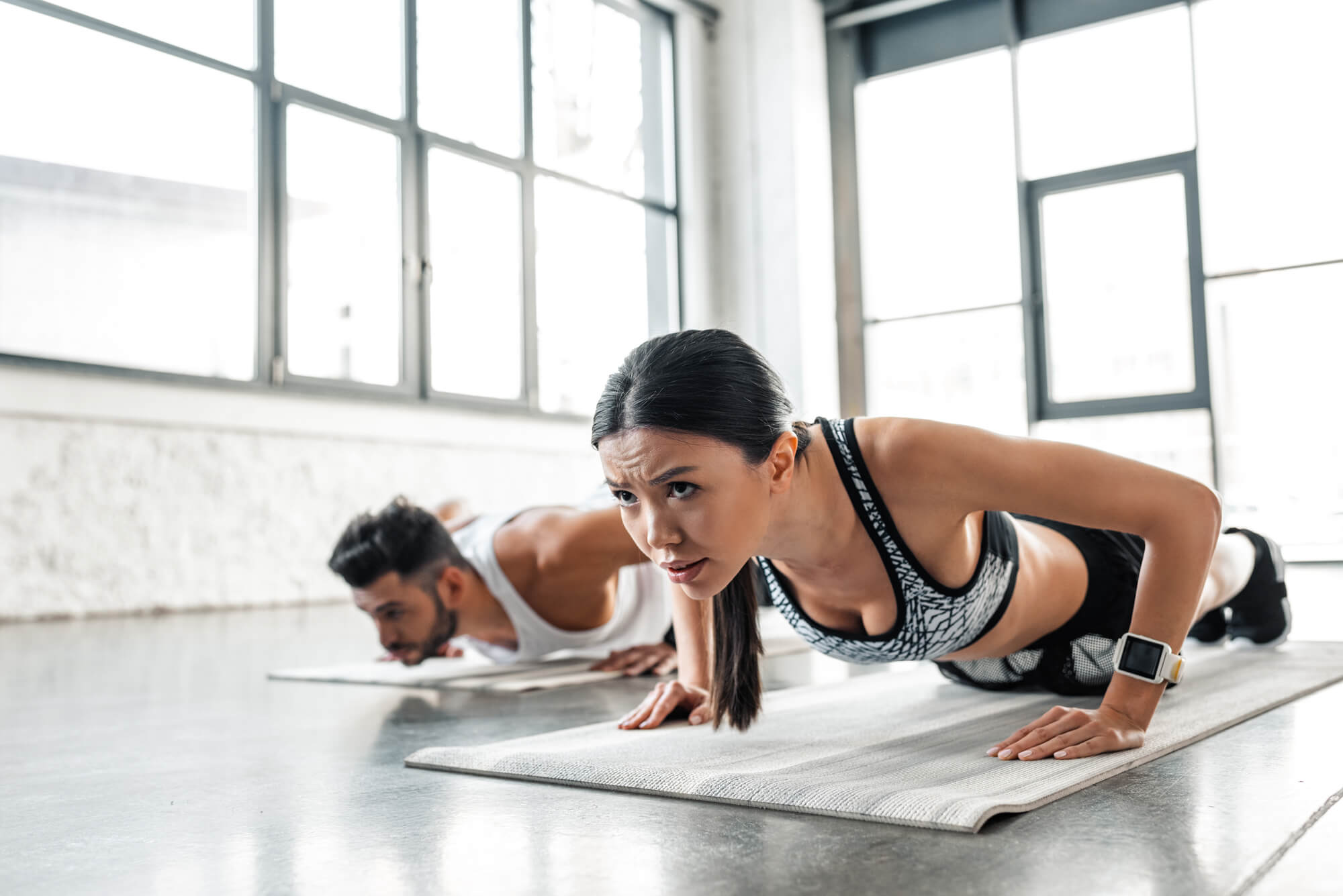 man and woman doing push ups | 2 Types of Exercises for Belly Fat