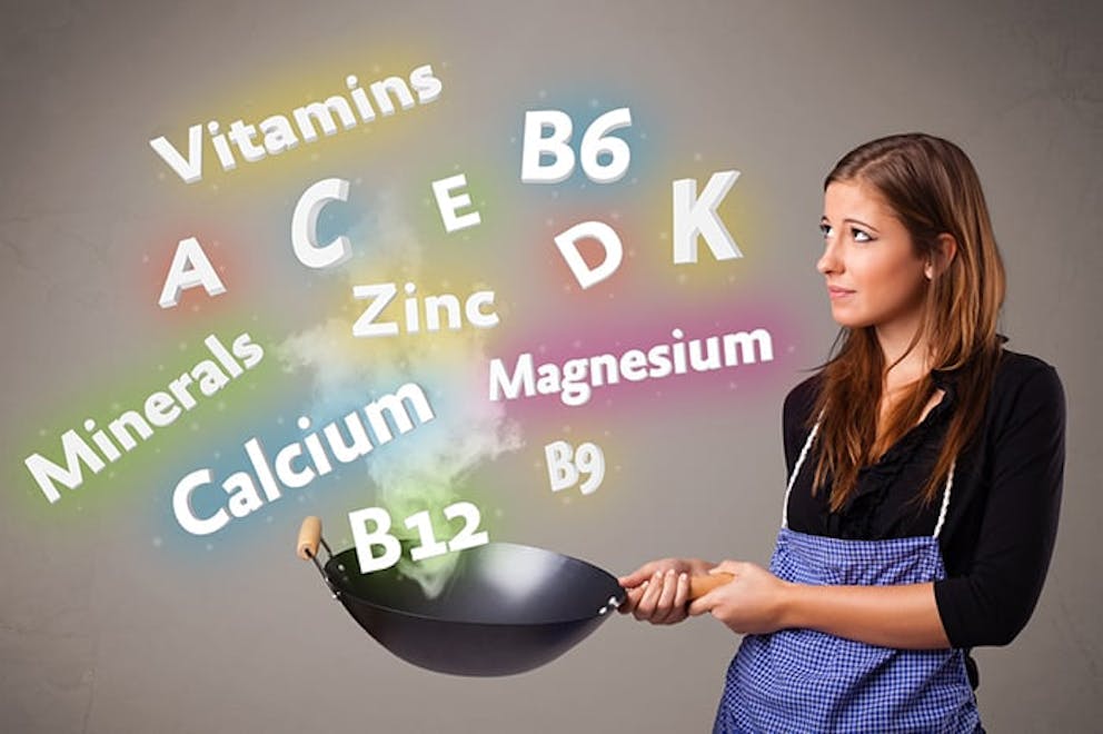 Woman in apron holds frying pan, cooking with nutrients, vitamins and minerals text in air.