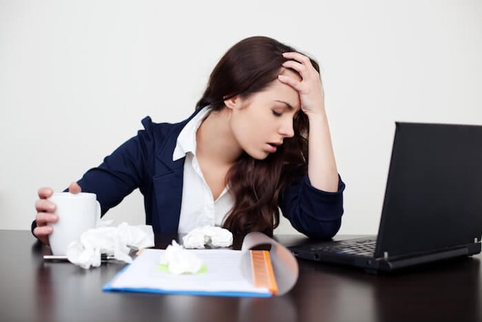 Stressed and tired woman at work | The Adrenal Fatigue Diet