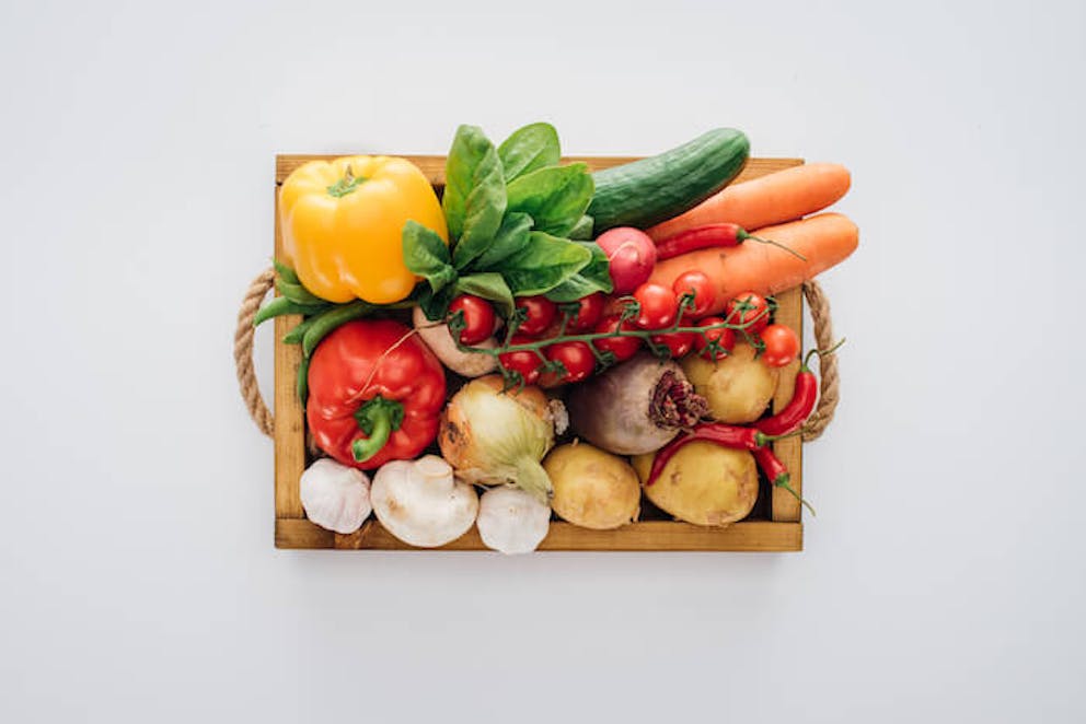 Top-view of box with fresh organic vegetables | The Adrenal Fatigue Diet