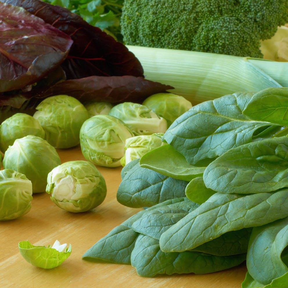 Healthy leafy vegetables close up like spinach, Brussels sprouts, and broccoli.