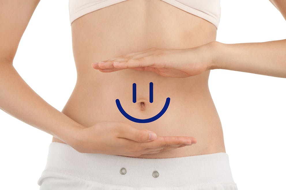Smiley face on woman’s stomach with healthy digestive system, soothe digestive tract.