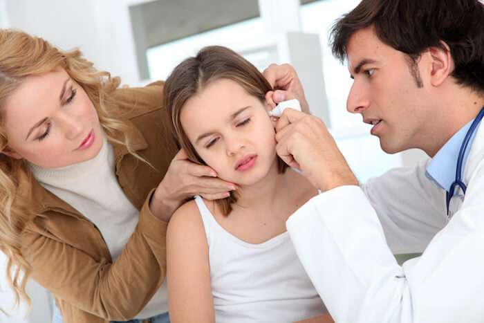 Young girl having her ear checked by a doctor. |  The Best Remedy for An Ear Infection