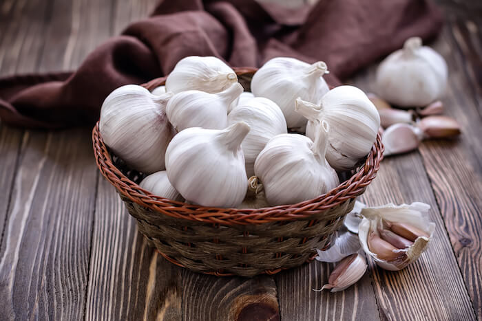 A basket of garlic sitting on a wood surface. |  The Best Remedy for An Ear Infection