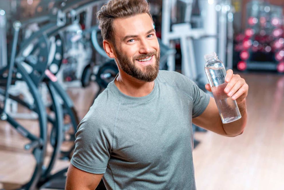 Lifestyle portrait of handsome muscular man drinking water in the gym | The Best Tips To Get Back On Track With Keto | how to get back on track