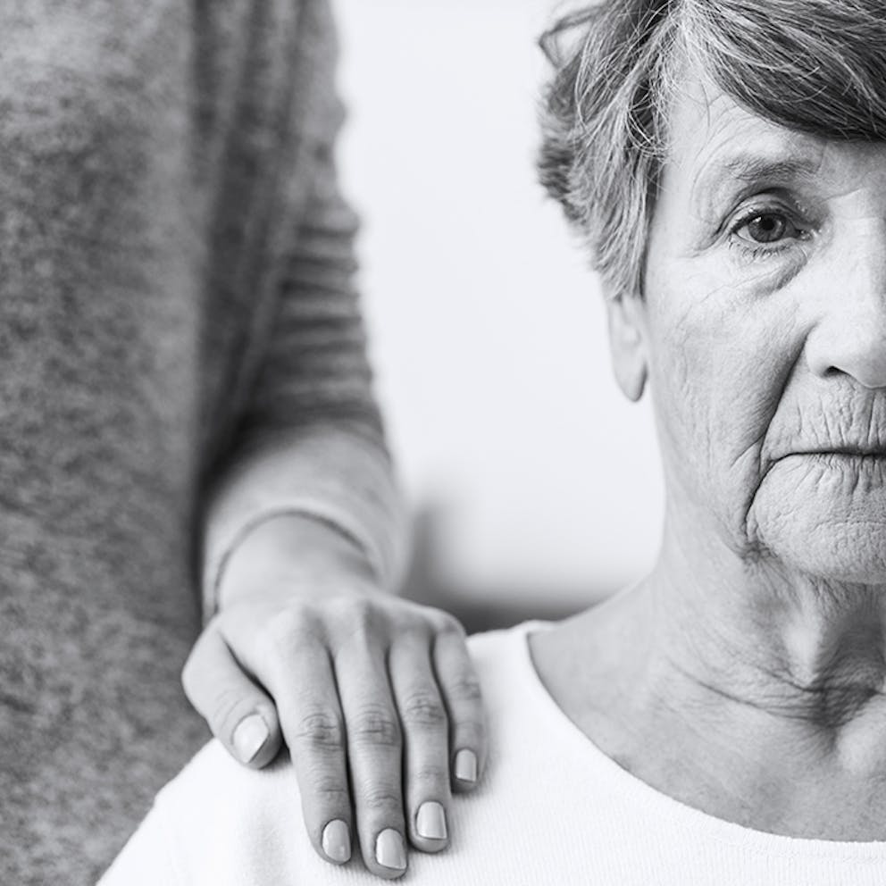 a black and white photo of an elderly woman with Alzheimer’s