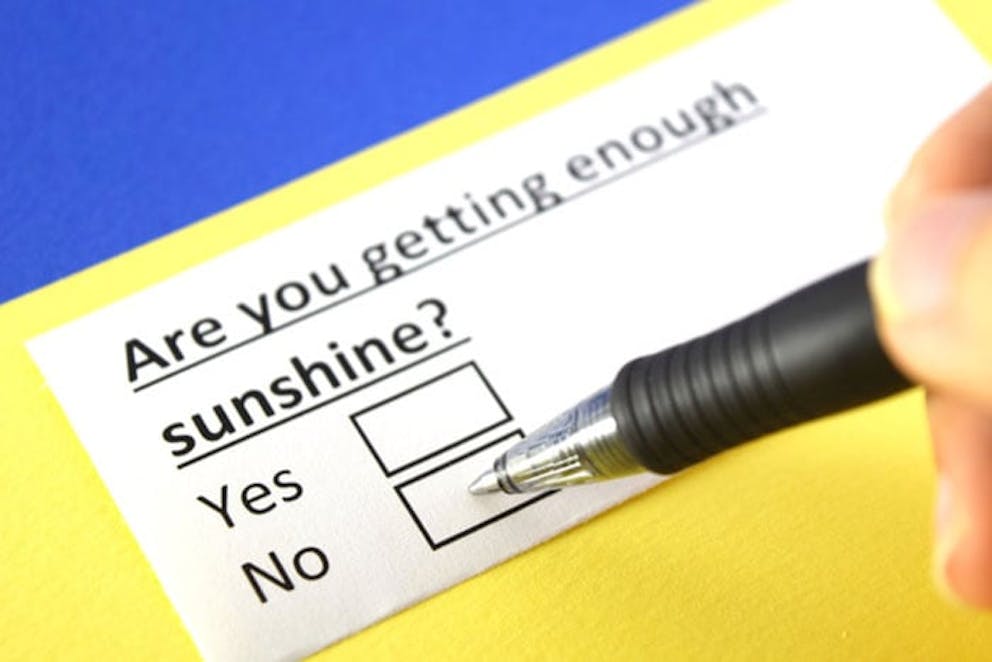 Pen to checkboxes on paper that says are you getting enough sunshine? Yes or no.