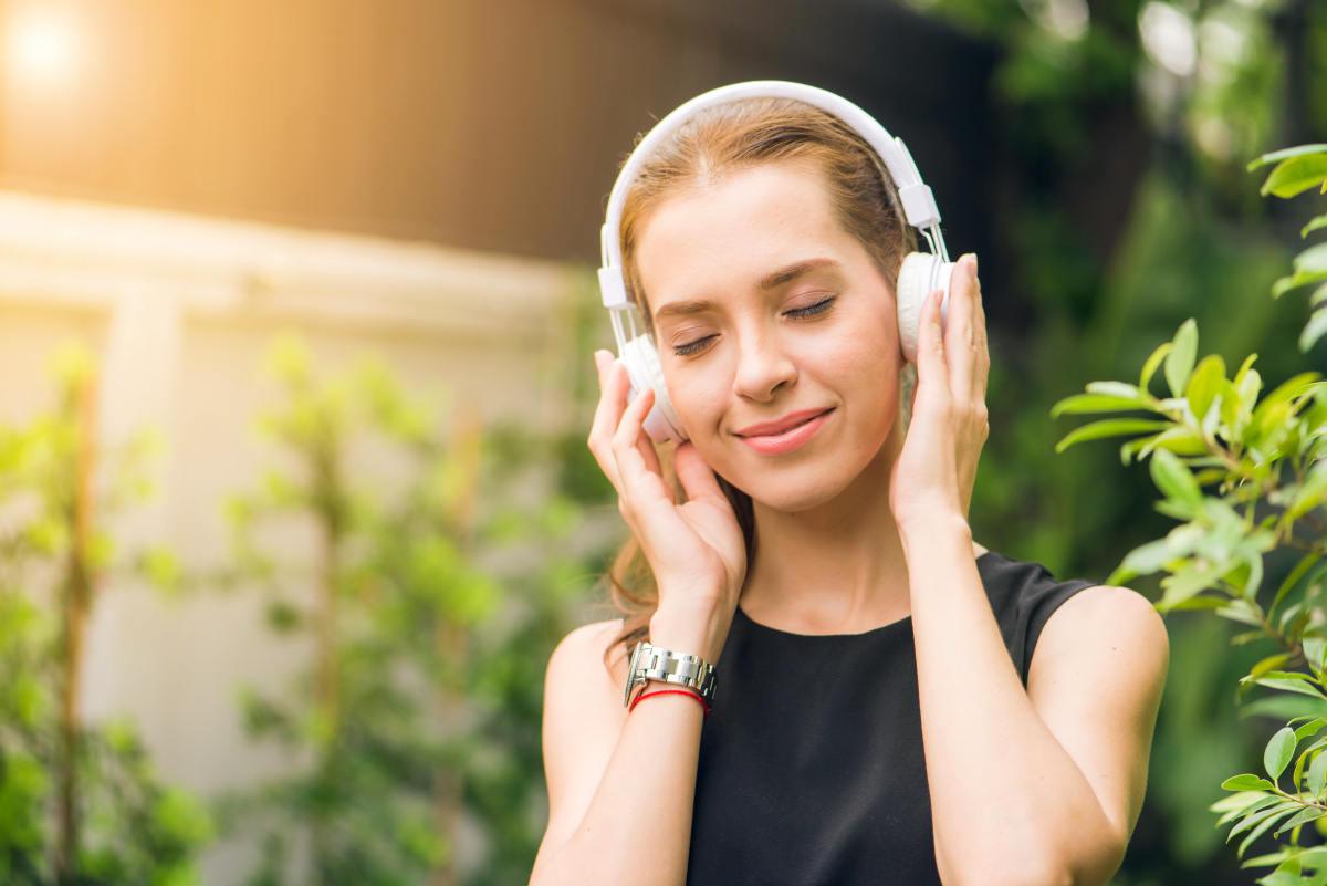 Woman Wearing Black Sleeveless Dress Holding White Headphone at Daytime | The Best Kale Shake Recipe You Need To Add in Your Weight Loss Diet NOW
