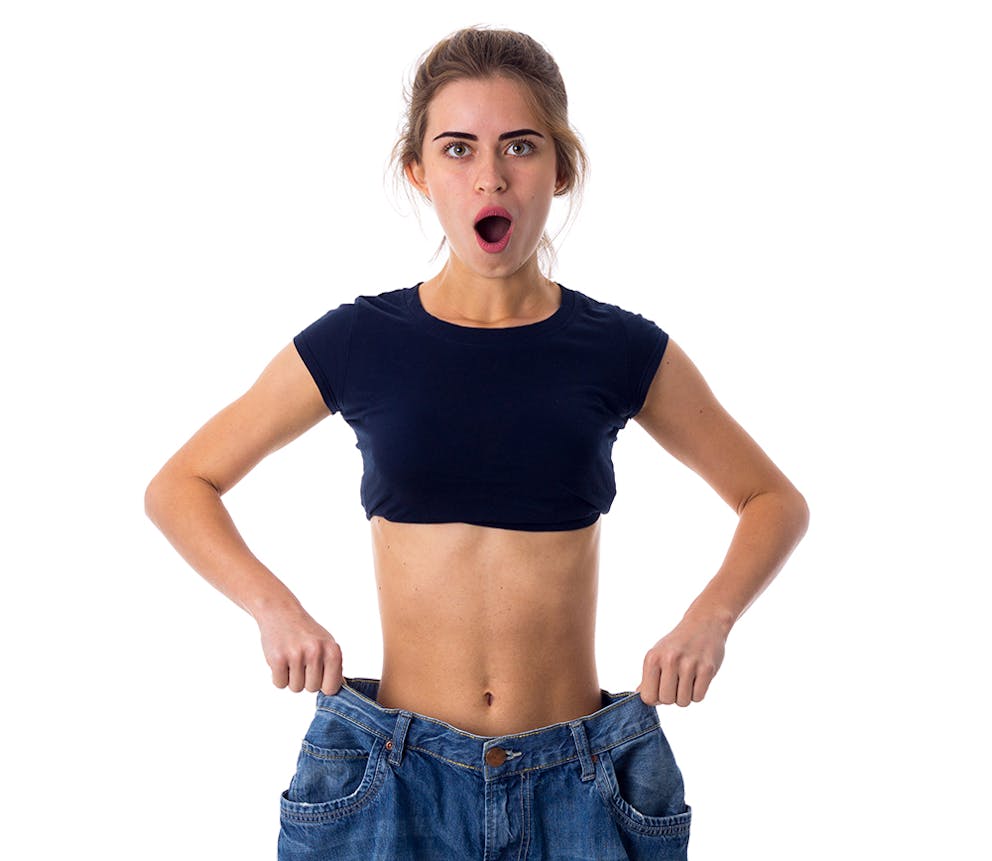 a young woman wearing jeans that are way too big