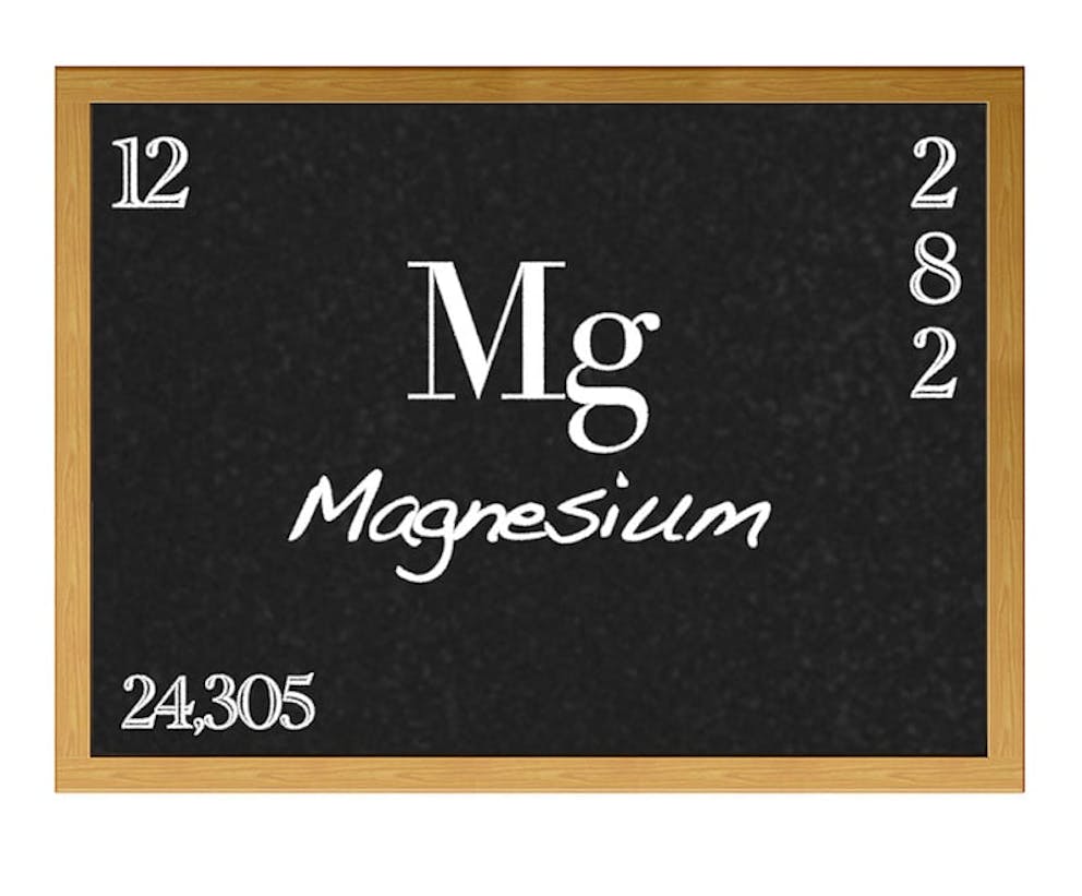 Magnesium element periodic table information on chalkboard, mineral.