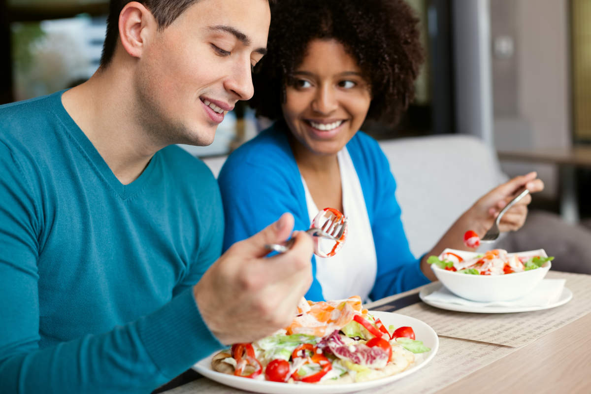 Lovely interracial couple having lunch at a restaurant | The Top Symptoms Of A Potassium Deficiency