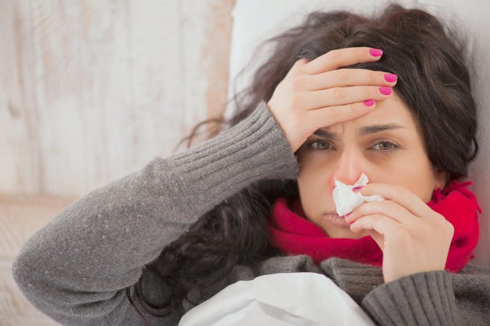 Frustrated sick woman with red nose lying in bed  | Use Vitamin D To Keep Viruses In Remission In Winter Months | does vitamin d destroy viruses