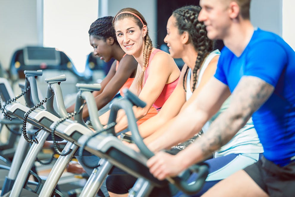 men and women in a group spin class