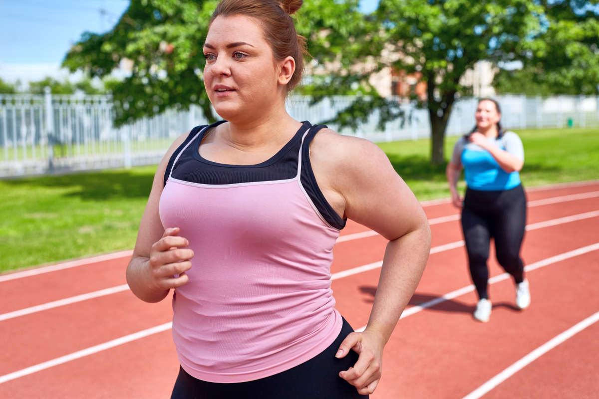 Young chubby women running and training on stadium | What Happens If You Stop Eating Sugar For Two Weeks | what happens when you stop eating sugar | what happens to your body when you stop eating sugar