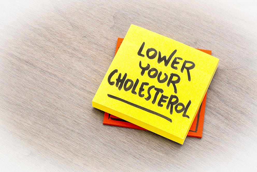 a notepad with the words Lower Your Cholesterol