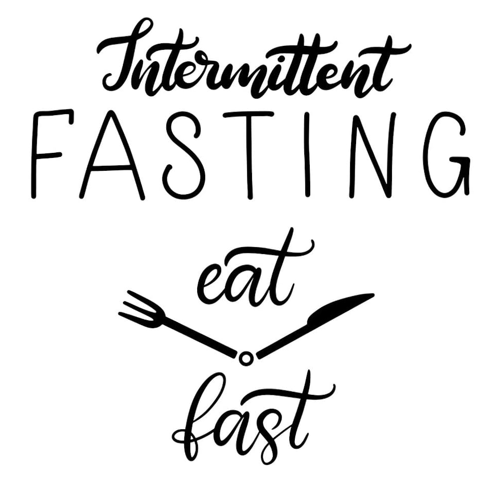 Intermittent fasting lettering with clock arms made of silverware showing eat and fast schedule.