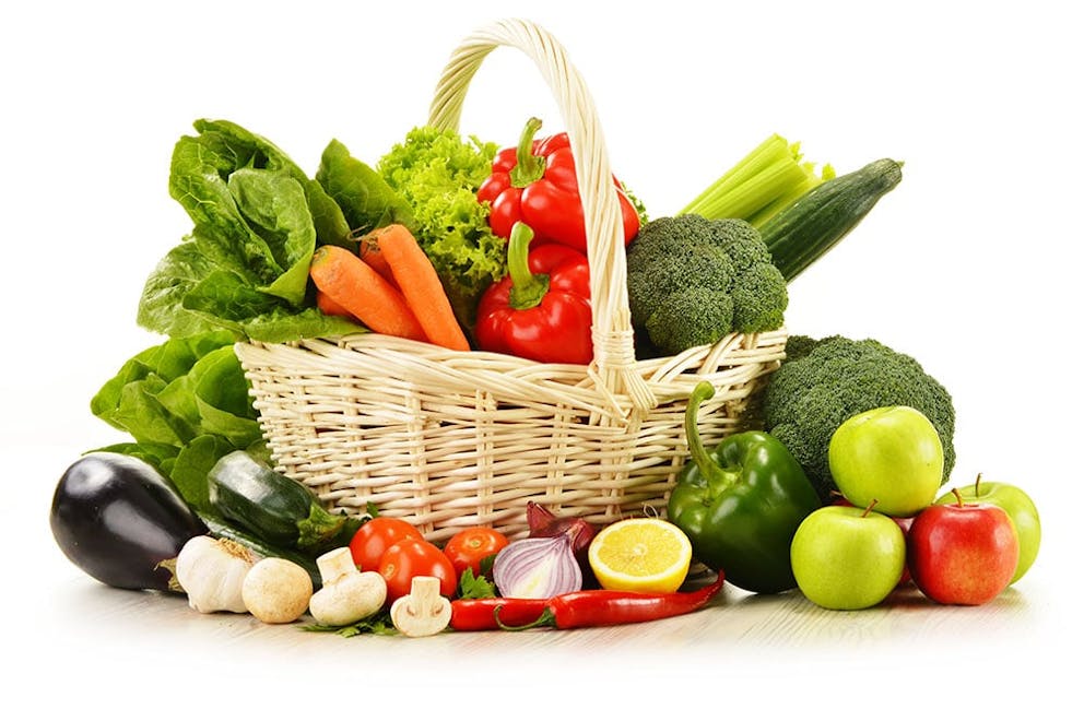 A variety of raw vegetables in a wicker basket