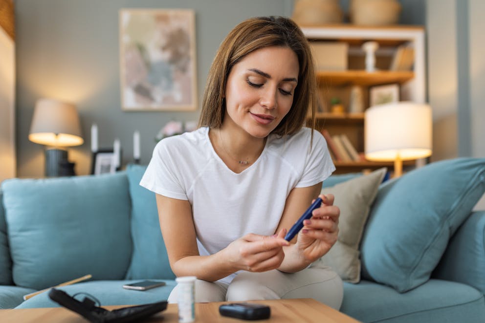 Young woman checking blood sugar