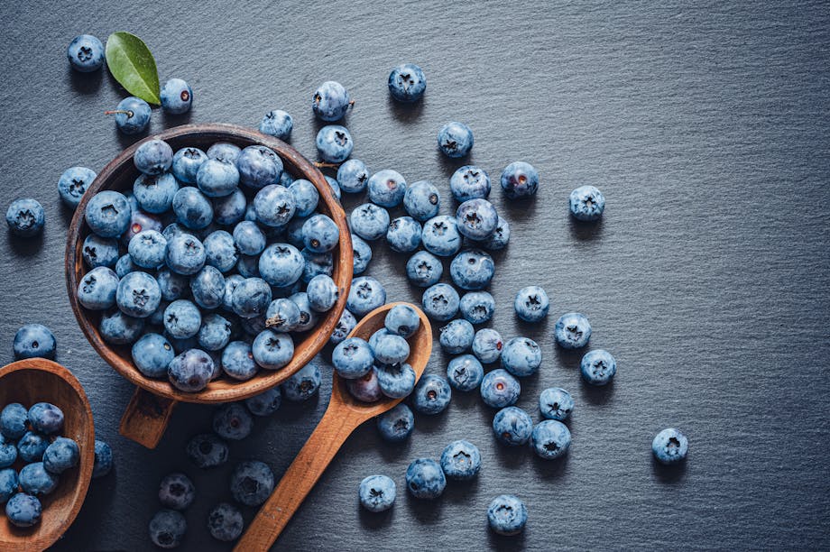 Blueberries in wooden bowl and spoon