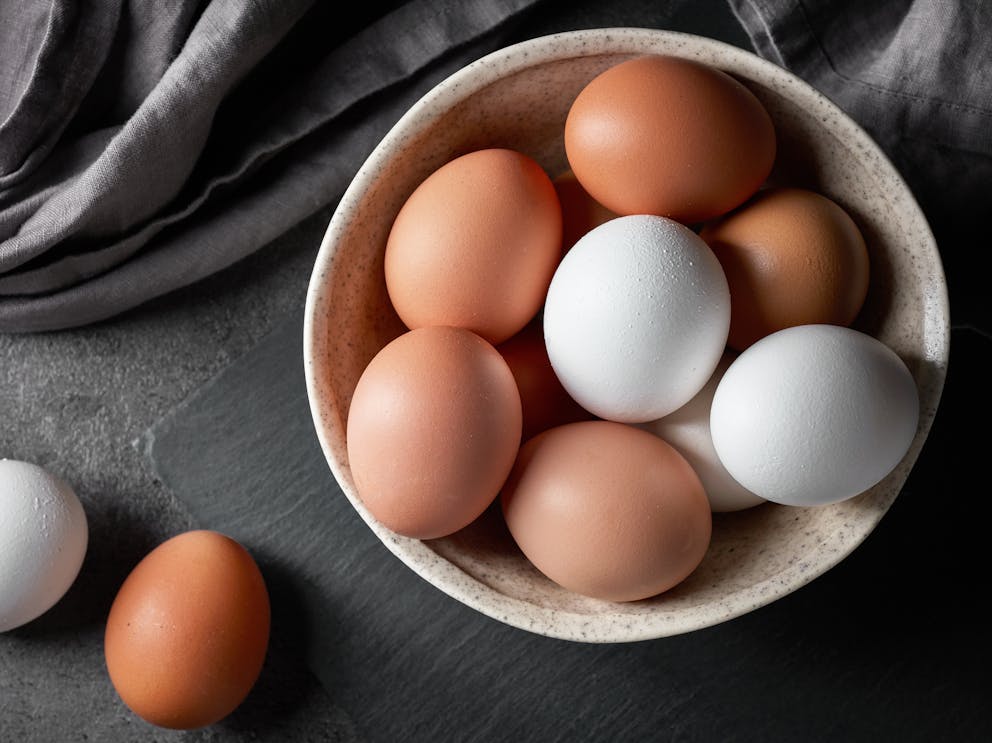 While and brown eggs in a bowl