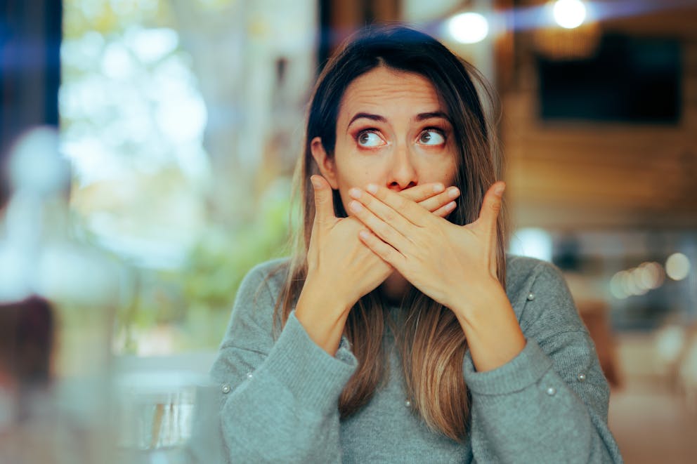 Burping woman in a restaurant