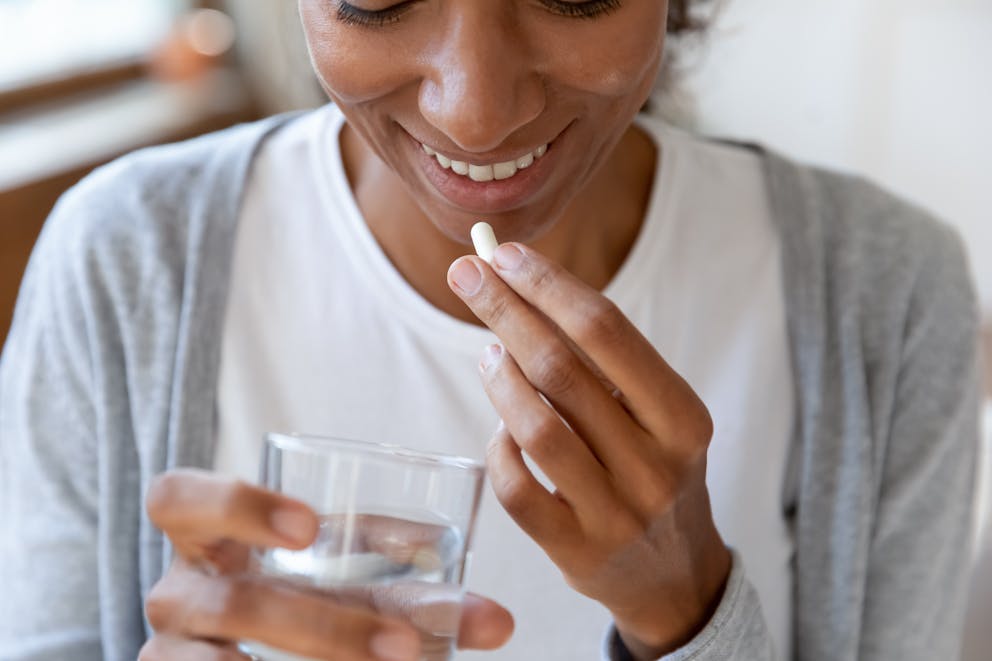 Woman taking a probiotic supplement