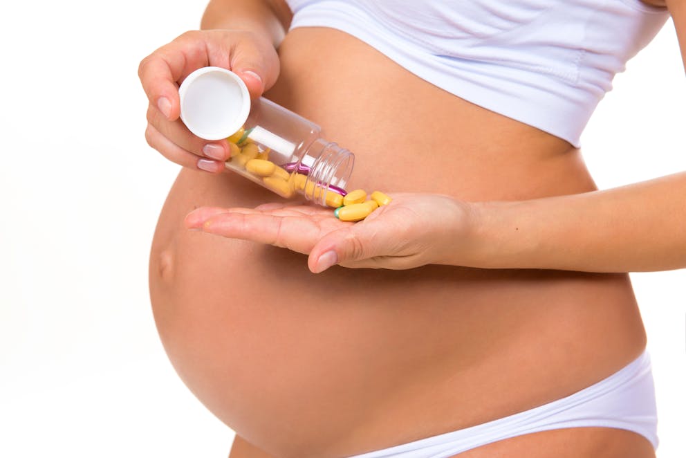 Pregnant woman taking supplements
