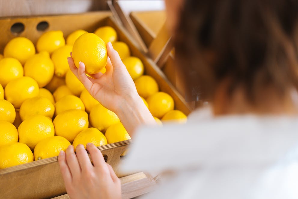 Woman selecting a lemon