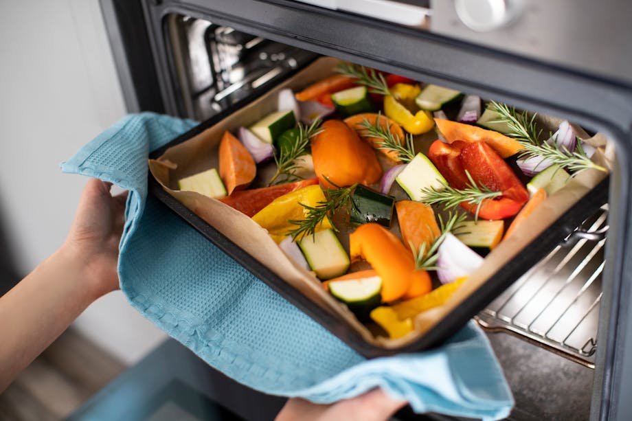 Placing vegetables in the oven