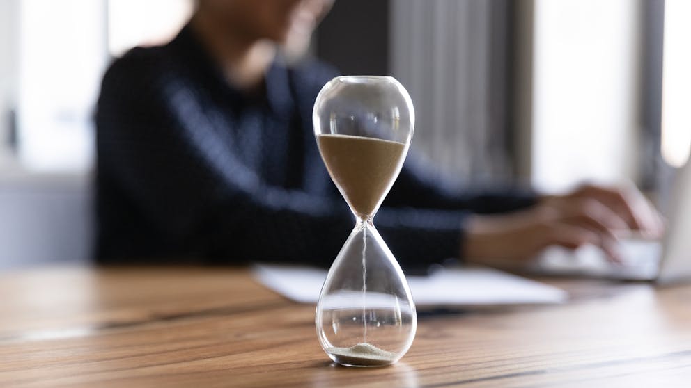 Person on a computer with a timer