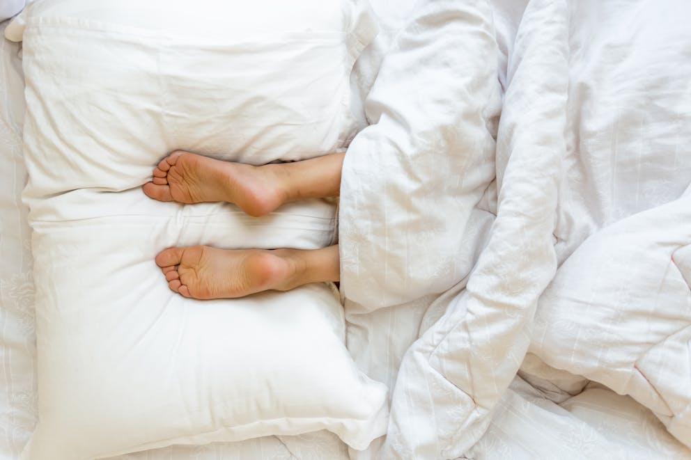 Feet lying on pillow