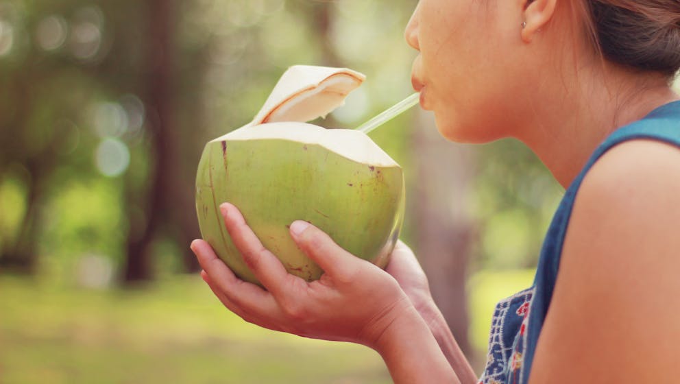 Woman drinking coconut water