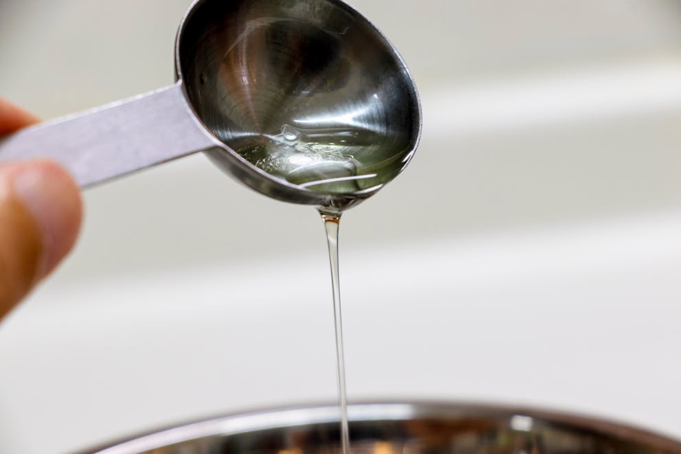 Oil dripping from measuring spoon