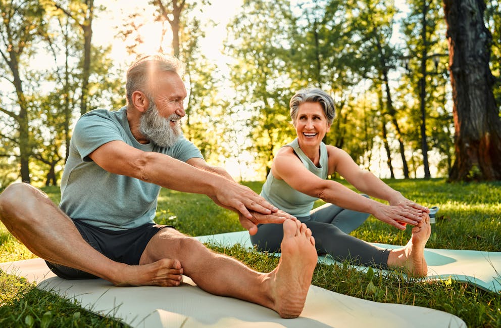 Healthy older couple stretching