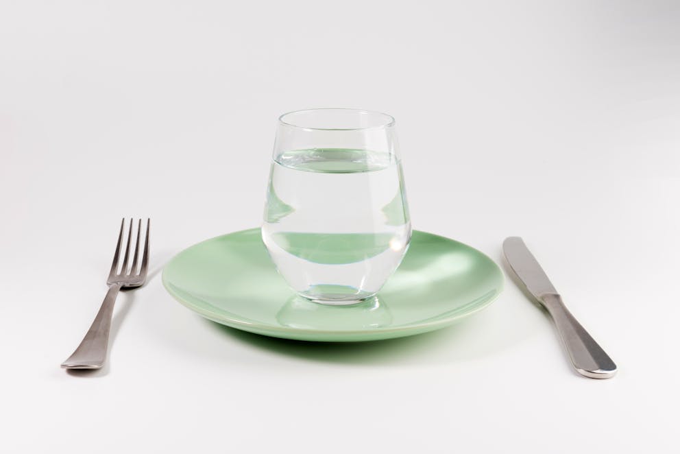 Glass of water on a plate
