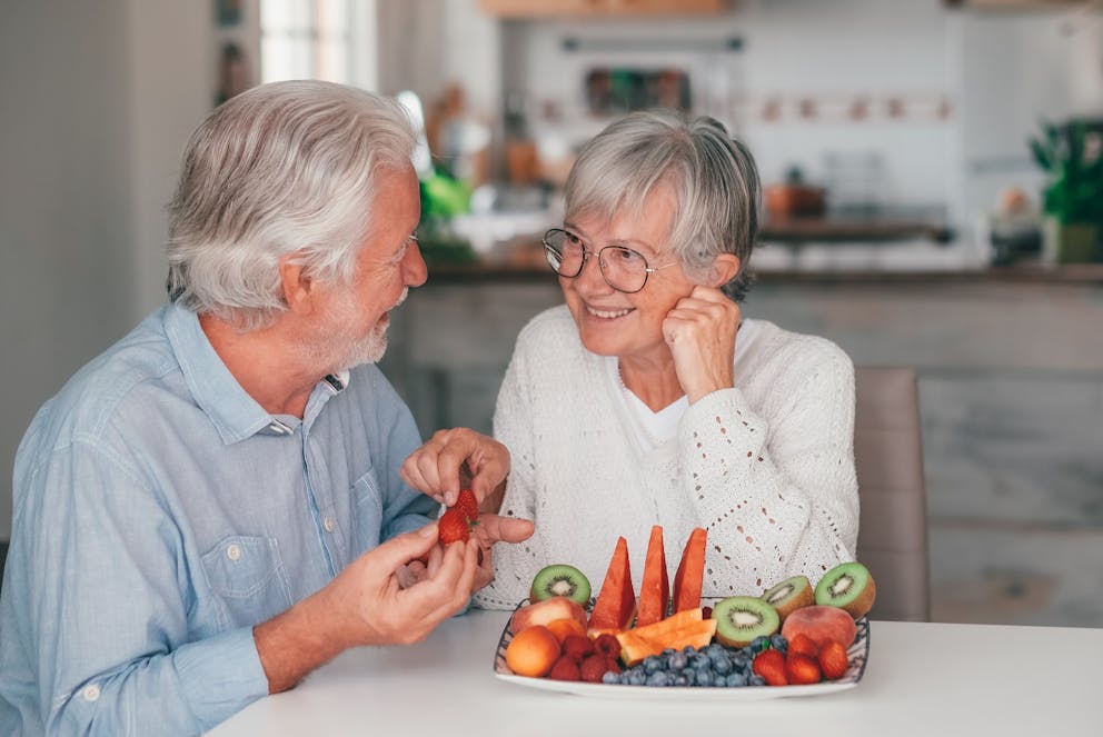 Senior couple eating fruits