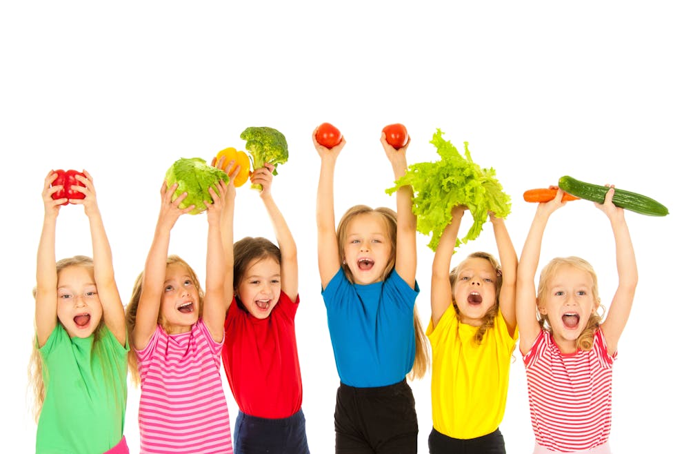 Children holding vegetables