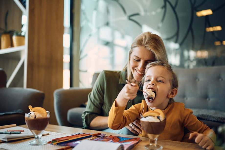 Mother and daughter eating chocolate mousse