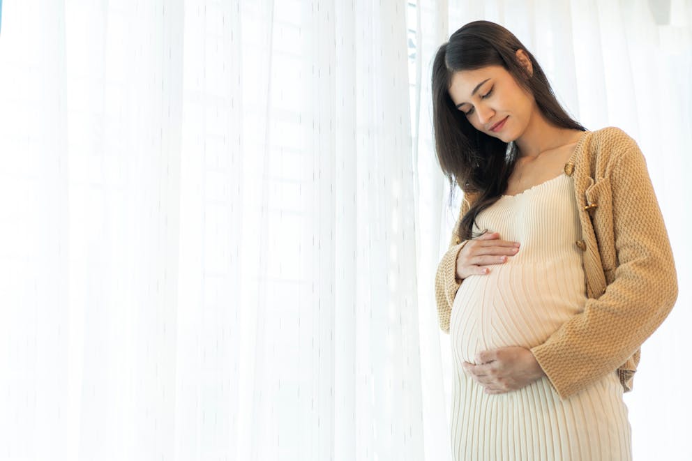 pregnant woman holding belly