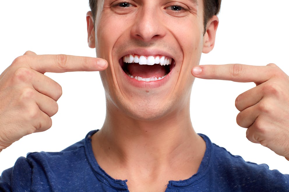 Man pointing at his teeth
