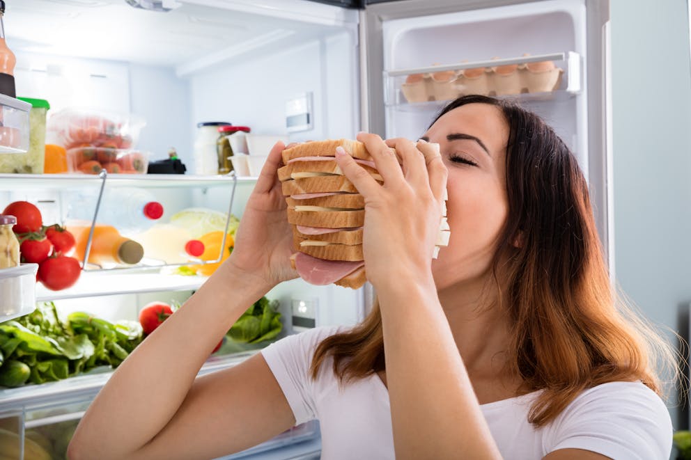 Woman eating a large sandwich