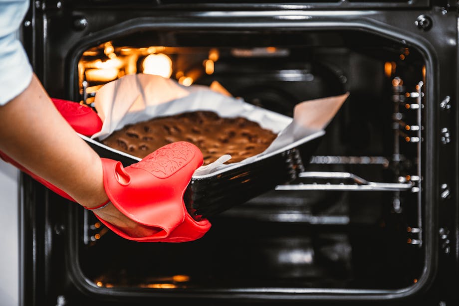 Removing chocolate cake from oven