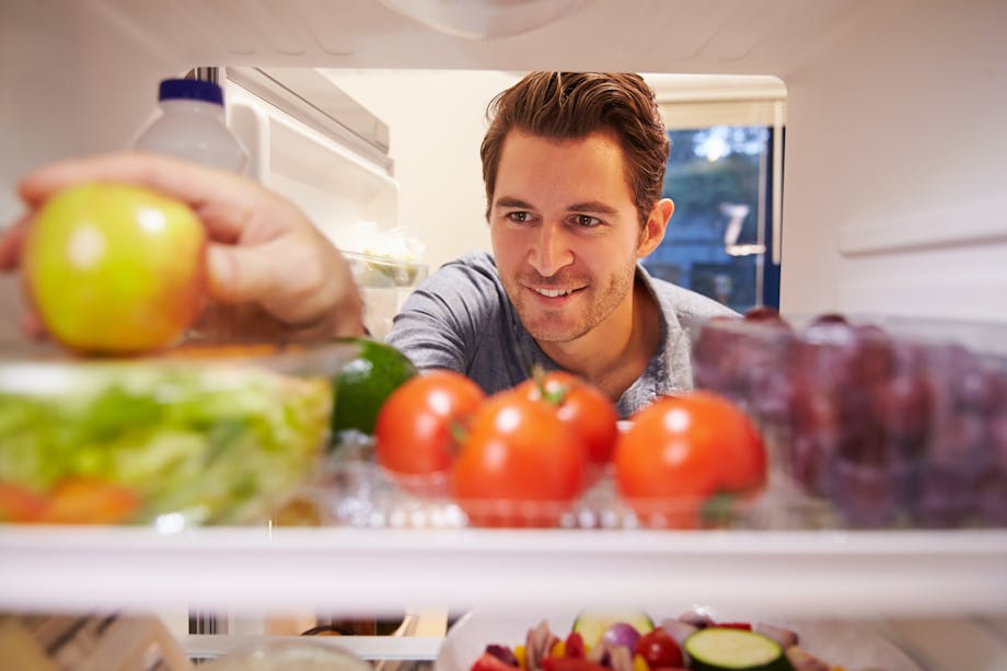 Man looking inside fridge