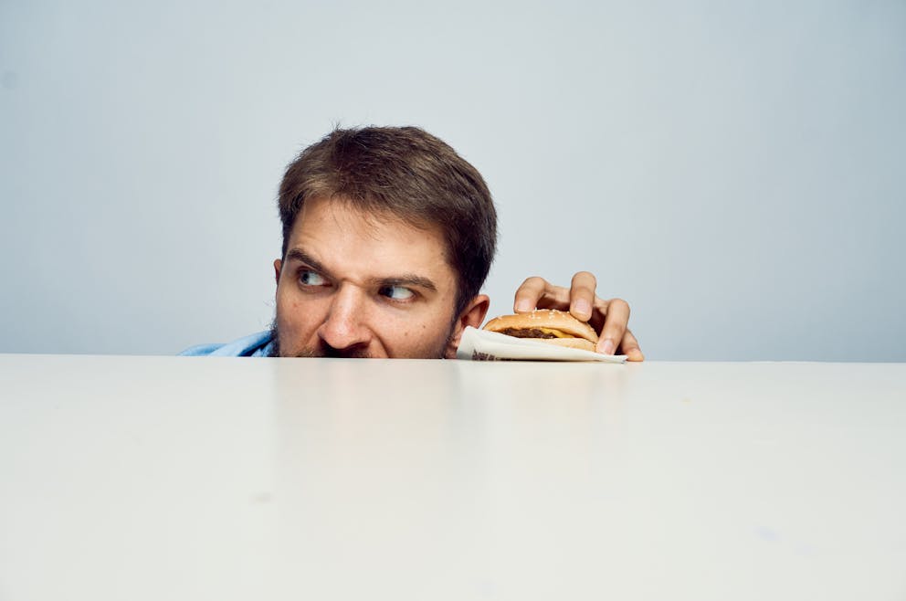 Man stealing a cheeseburger