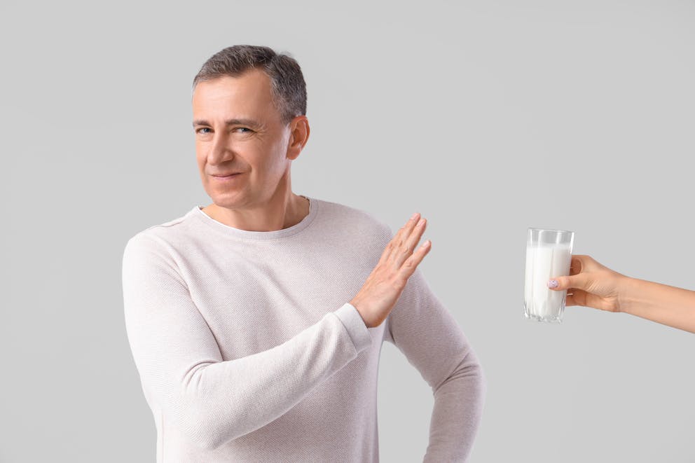 Man refusing a glass of milk