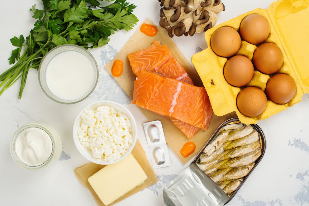 Natural sources of vitamin D and K2. Healthy food background: salmon, eggs, butter.