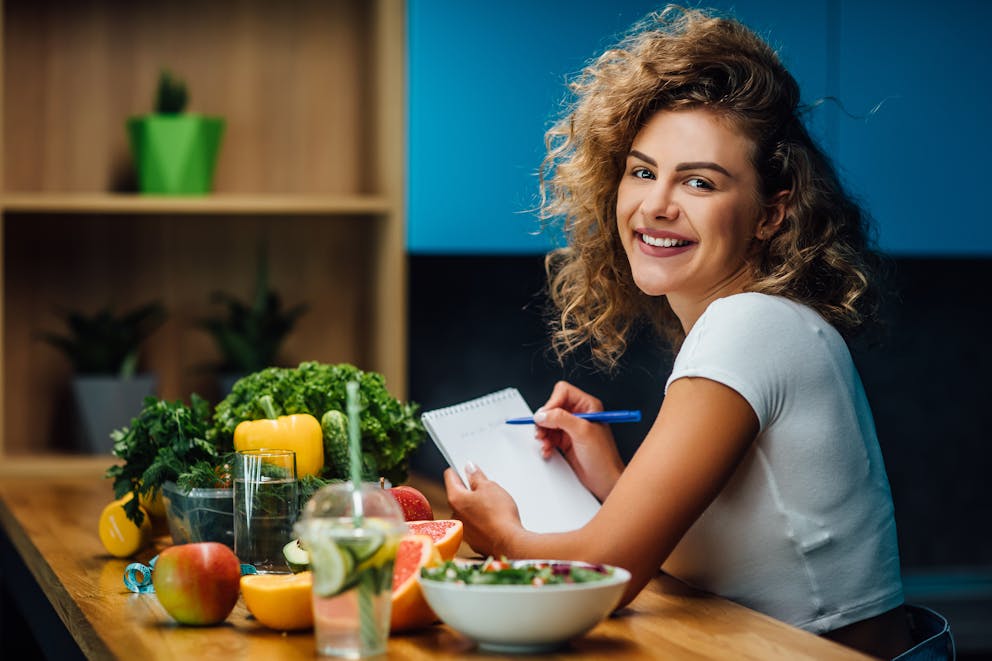 Woman writing a food journal