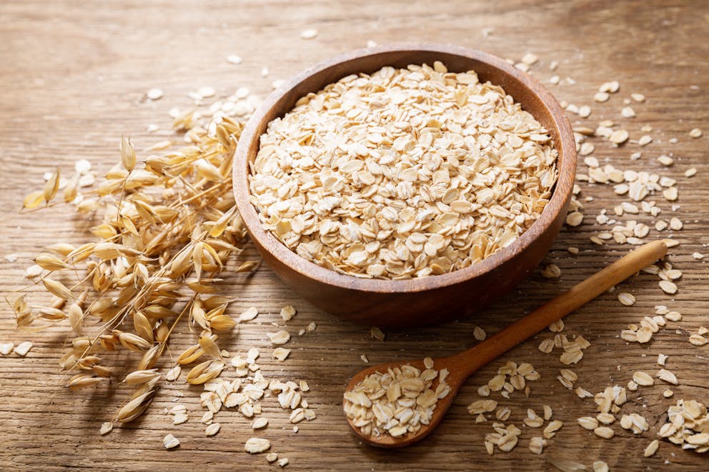Wooden bowl of oatmeal flakes