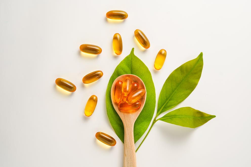 Vitamin capsules in a spoon